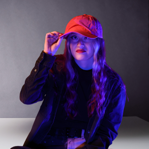 Woman wearing a baseball cap that sits too deep on a smaller head
