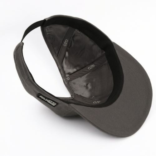 Angled interior view of the gray GZO STRETCH showing the satin lining, PISTIL crown opening, flexible stretch closure, and flat bill.