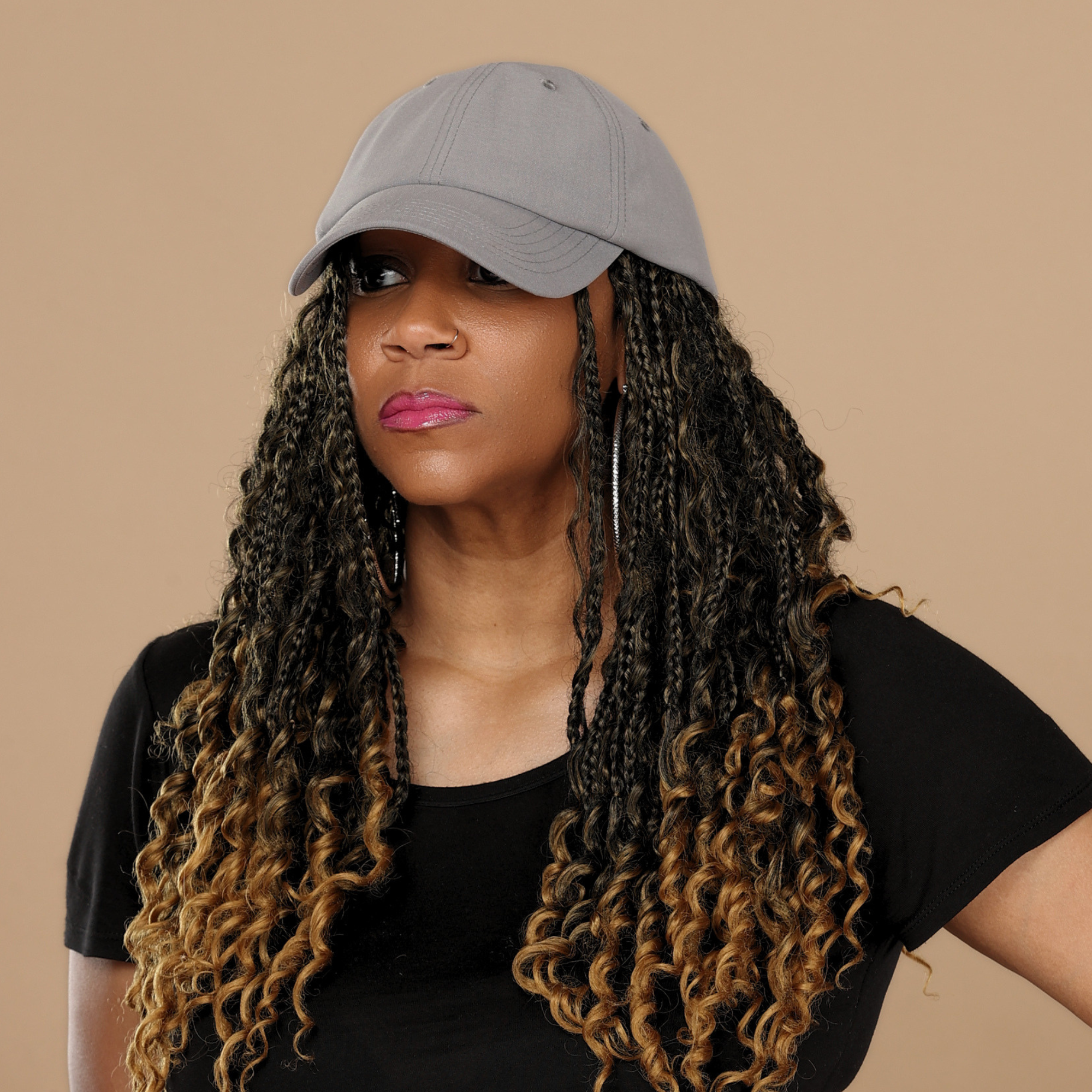 Model wearing the gray Rosebloom HLO closed crown hat, showing room for locs, textured hair, and protective styles.