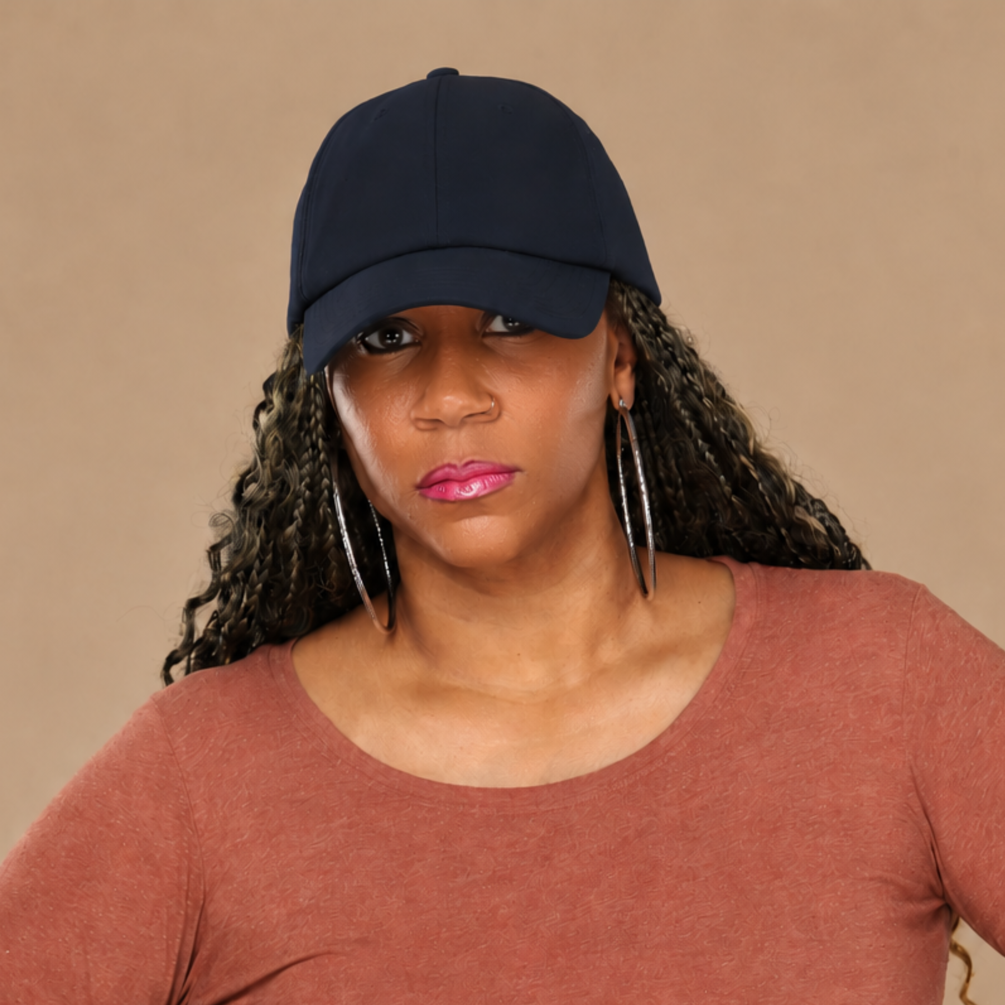 Model wearing the navy Rosebloom HLO closed crown hat, showing room for locs, textured hair, and protective styles.