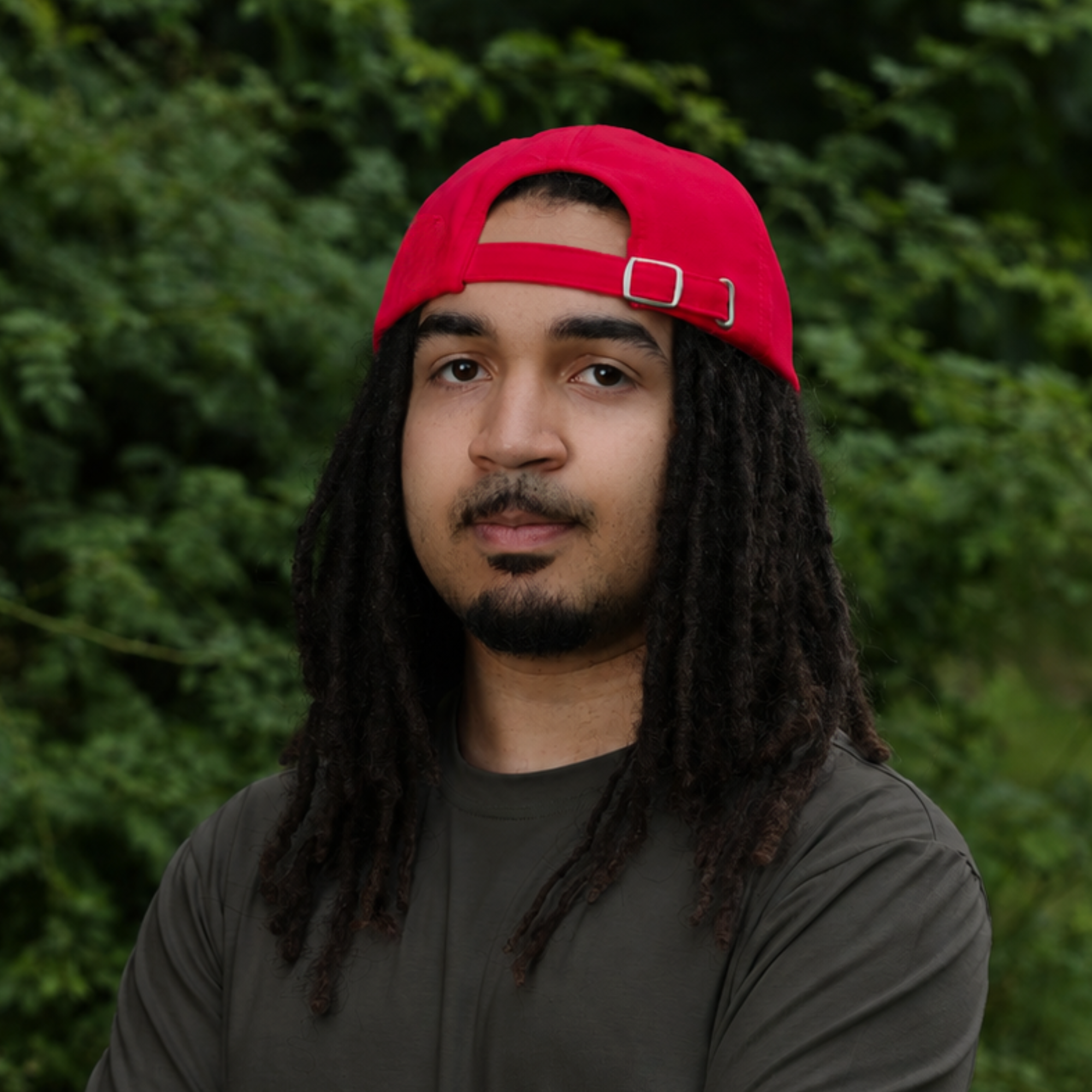 Model wearing backward the red Rosebloom HLO closed crown hat, showing room for locs, textured hair, and protective styles.