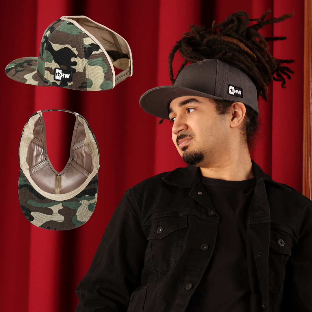 a young man with locs is wearing a satin lined snap back that is well fitting. the back is open so that he can pull his locs up and through and pull his hair into a ponytail. there are pictures of the hat showing the hair opening, which is large enough for protective hairstyles.