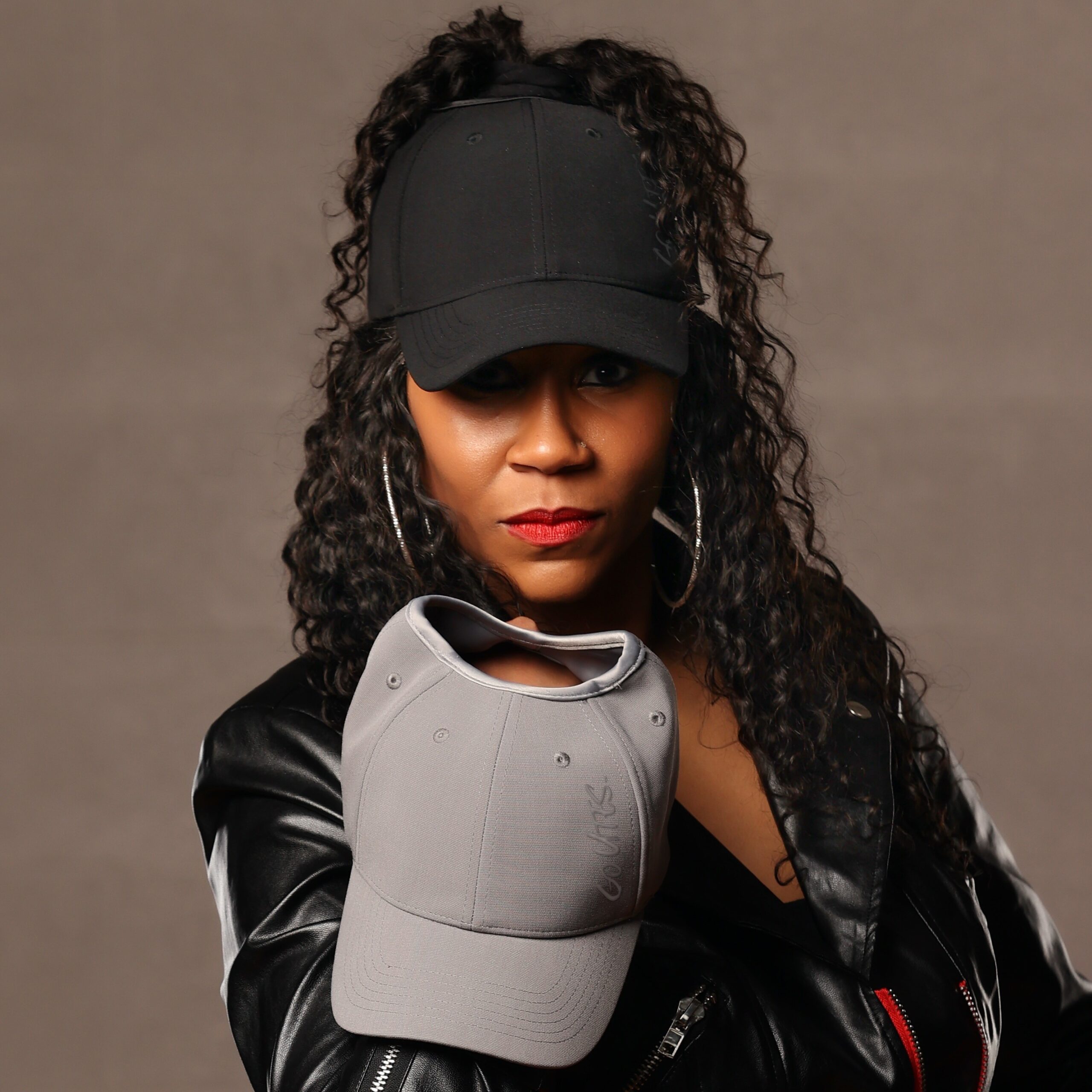 Black woman wearing a University of Utah satin lined ponytail hat for textured hair