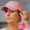a woman with hair loss is shown wearing a satin lined University of Utah Compassion Cap