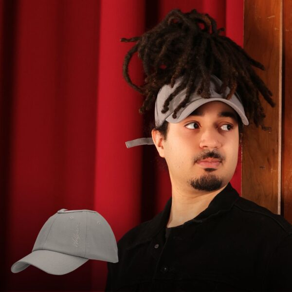 Black man wears an NC State Wolfpack satin lined high ponytail baseball hat for locs and textured hair