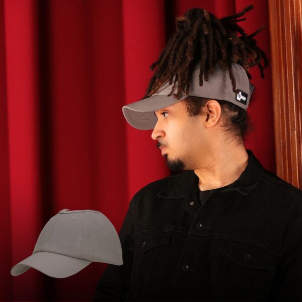 Black man wears an NC State Wolfpack satin lined high ponytail baseball hat for locs and textured hair
