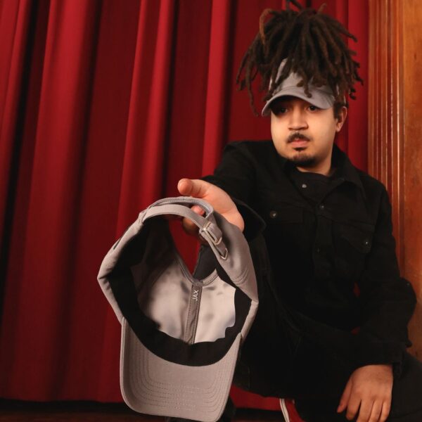 Black man wears an NC State Wolfpack satin lined high ponytail baseball hat for locs and textured hair