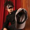 Black man wears an NC State Wolfpack satin lined high ponytail baseball hat for locs and textured hair