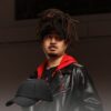 Black man wears an NC State Wolfpack satin lined high ponytail baseball hat for locs and textured hair