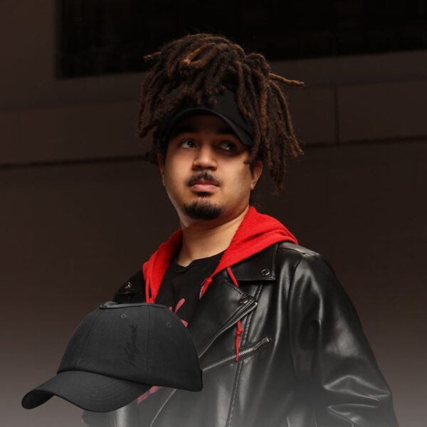 Black man wears an NC State Wolfpack satin lined high ponytail baseball hat for locs and textured hair