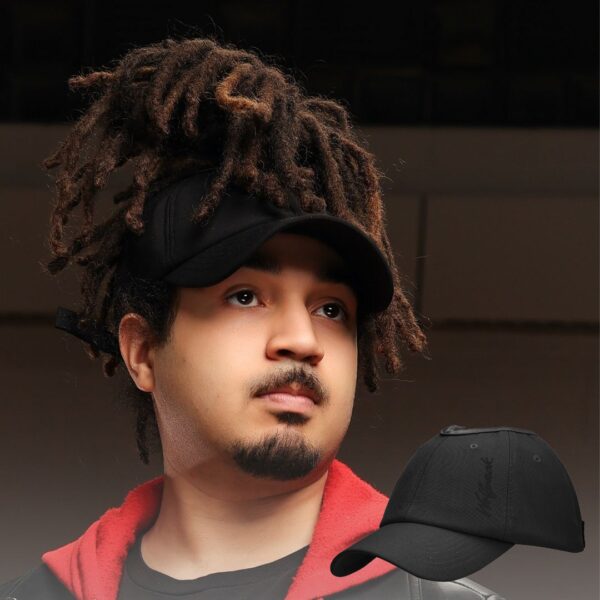 Black man wears an NC State Wolfpack satin lined high ponytail baseball hat for locs and textured hair