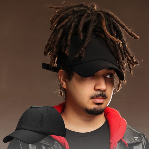 Black man wears an NC State Wolfpack satin lined high ponytail baseball hat for locs and textured hair