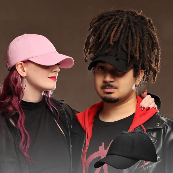Black man wears an NC State Wolfpack satin lined high ponytail baseball hat for locs and textured hair, stands with woman in pink hat