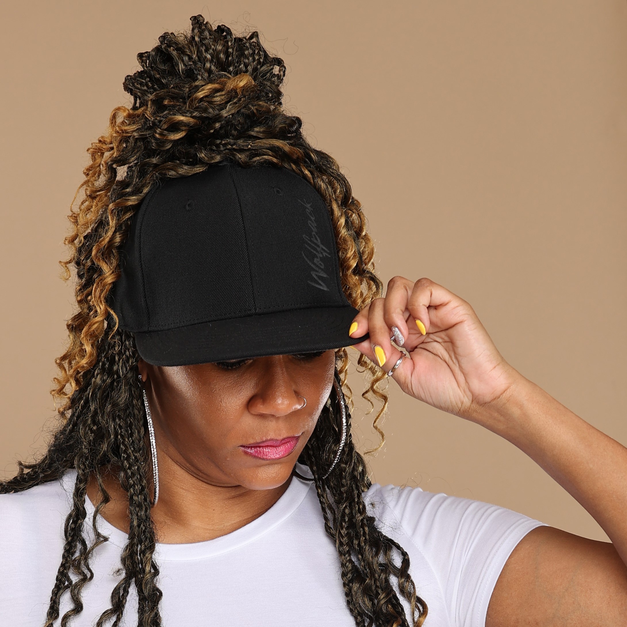 Black woman wears satin lined NC State Wolfpack stretch fit ponytail baseball hat for locs and textured hair