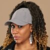 Black woman wearing NC State Wolfpack satin lined ponytail hat for textured hair