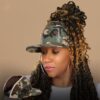 Black woman wears satin lined NC State Wolfpack stretch fit ponytail baseball hat for locs and textured hair